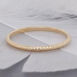 Solid gold stack ring patterned with small dots