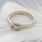 Solid gold double love knot ring with twisted middle band