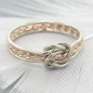 Solid gold double love knot ring with twisted middle band